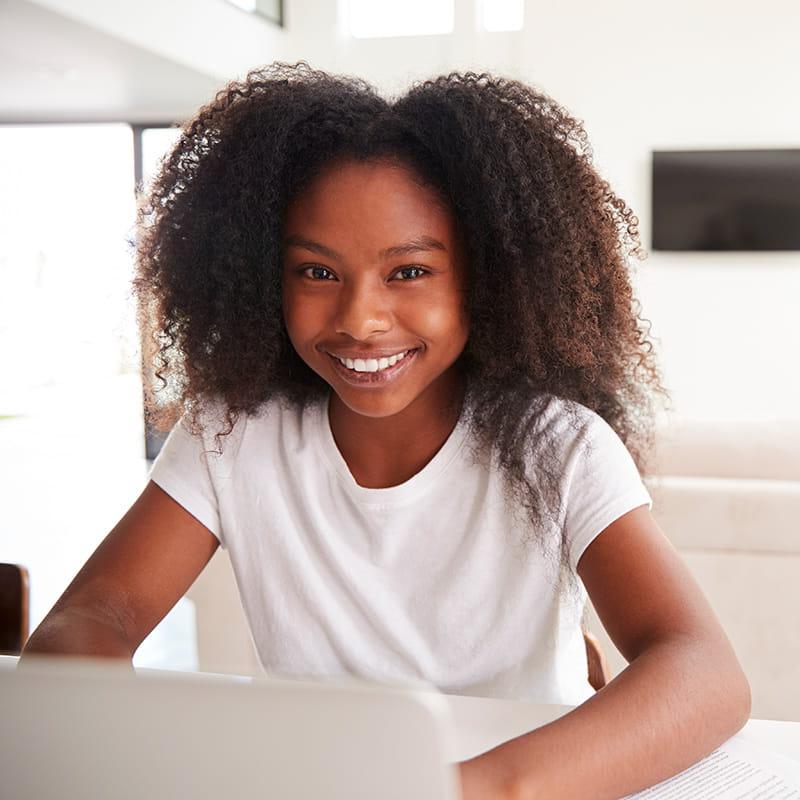 happy young girl using laptop