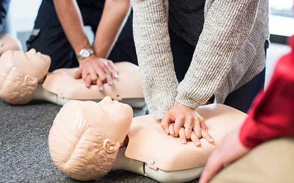 Hands performing CPR in CPR class