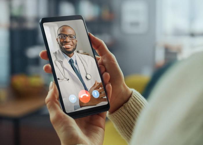 Physician on smart phone for telehealth visit. 